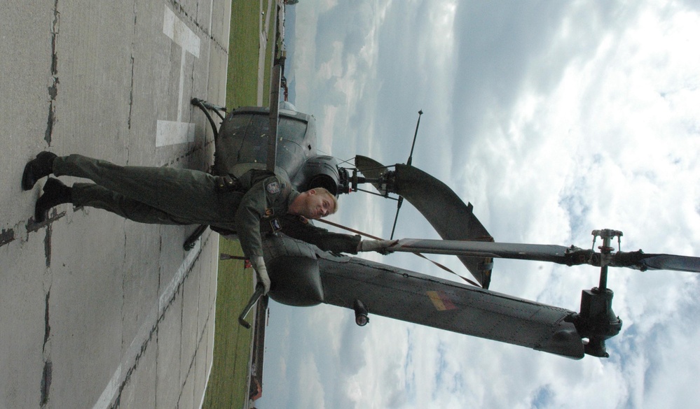 U.S. Air Force Pilot Inspects German Helicopter in Kosovo