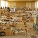 Mechanics Scavenge Parts for Vehicles Before Iraq Deployment