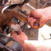 Mechanic Tightens Bolt on Humvee in Iraq