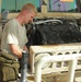 Soldier Maintains Humvee in Iraq