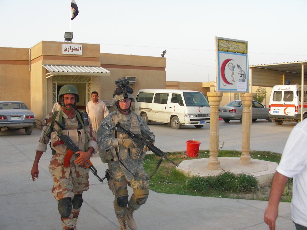 Iraqi, American Soldiers Assist Wounded Man at Hit Hospital