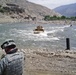 Marines Cross Pech River in Armored Vehicles as Soldier Observes
