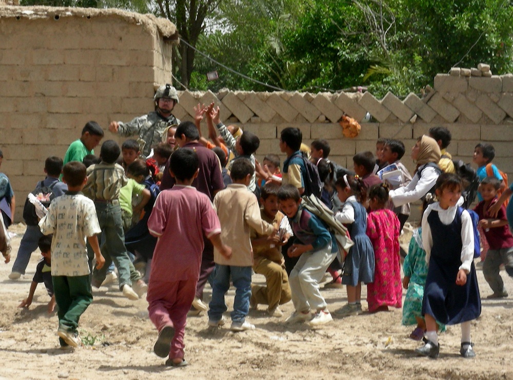Cavalry Soldier Engages with Local Children During Presence Patrol in 12 Dubai, Iraq