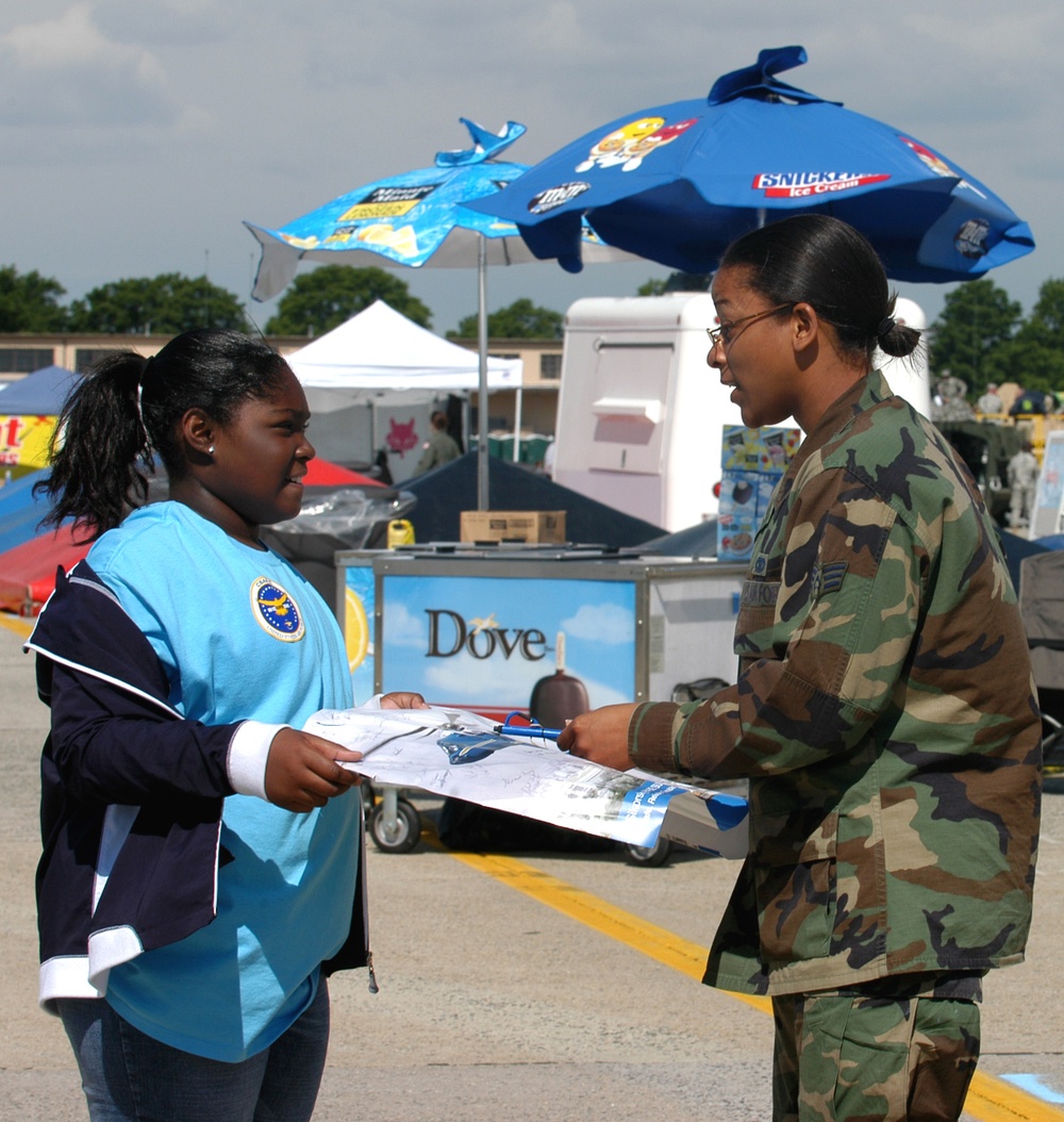 Young Girl Seeks Autograph from Female Airman at Andrews Air Force Base