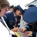 Coast Guard, Air Force Personnel Sign Indianapolis 500 Flag