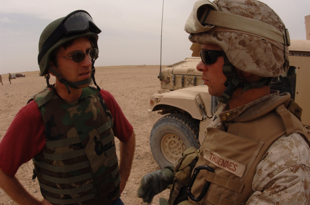 Civilian Investor Discusses Counter-IED Training with Marine in Kuwait