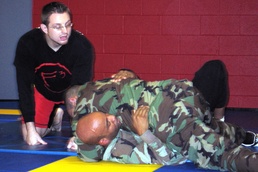 Civilian Instructor Guides Wounded Warrior Through Combatives Training