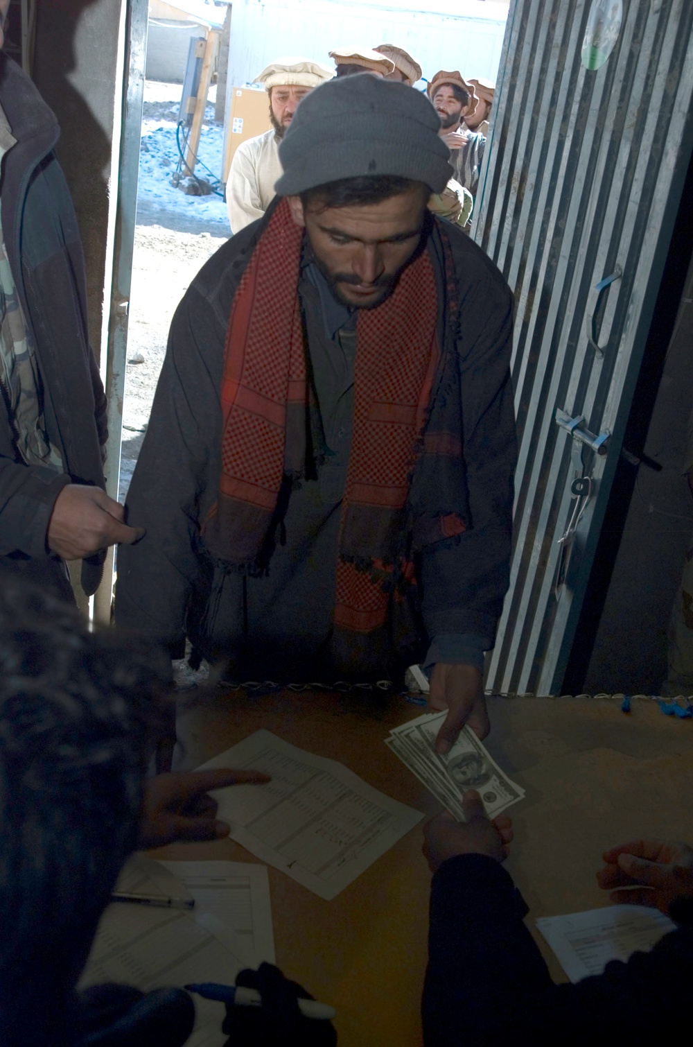 Afghan Security Force Member Receives Severance Pay After Demobilization Ceremony