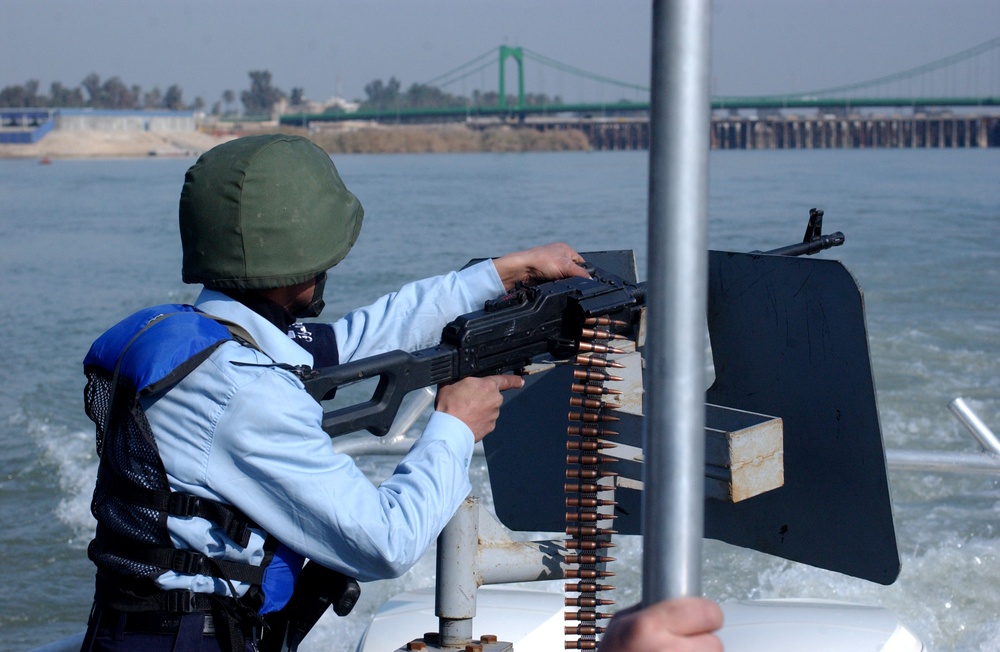 Iraqi Policeman Patrols Tigris River Bridge