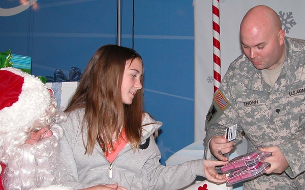 Military Family Member Receives Holiday Gift at Operation Christmas Event