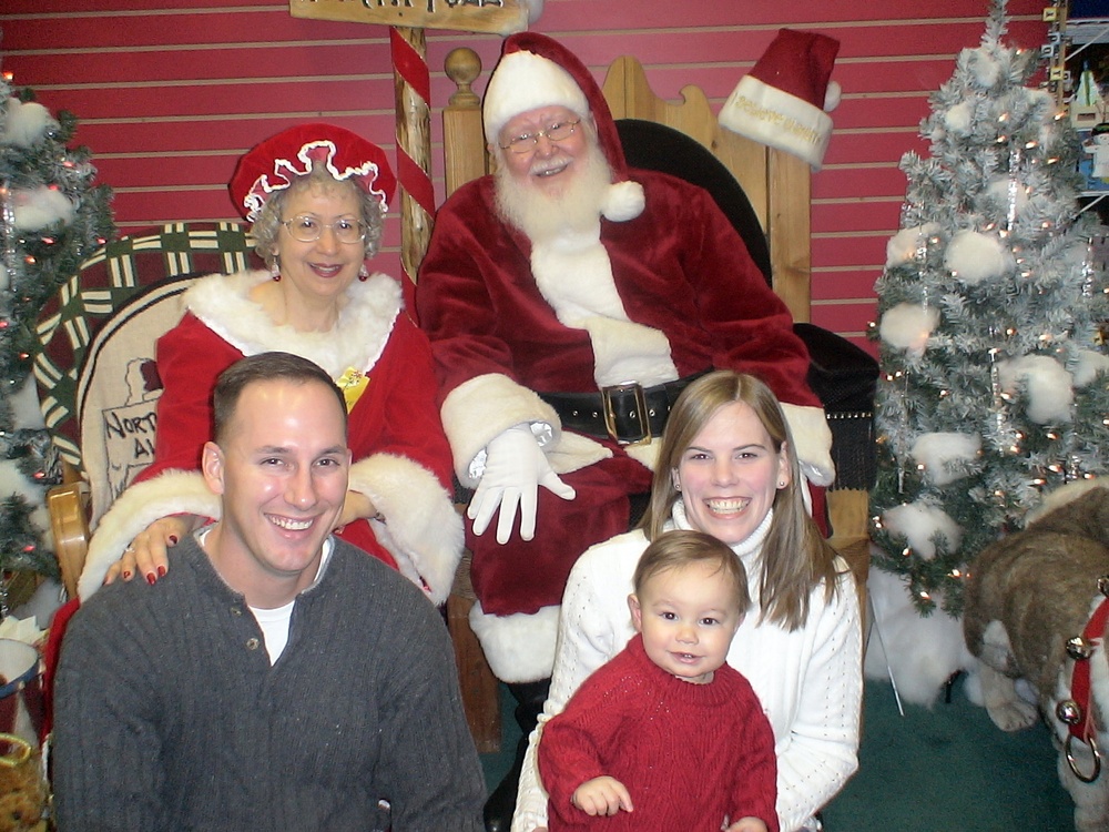 Family Poses for Holiday Portrait with Santa and Mrs. Claus in North Pole, Alaska