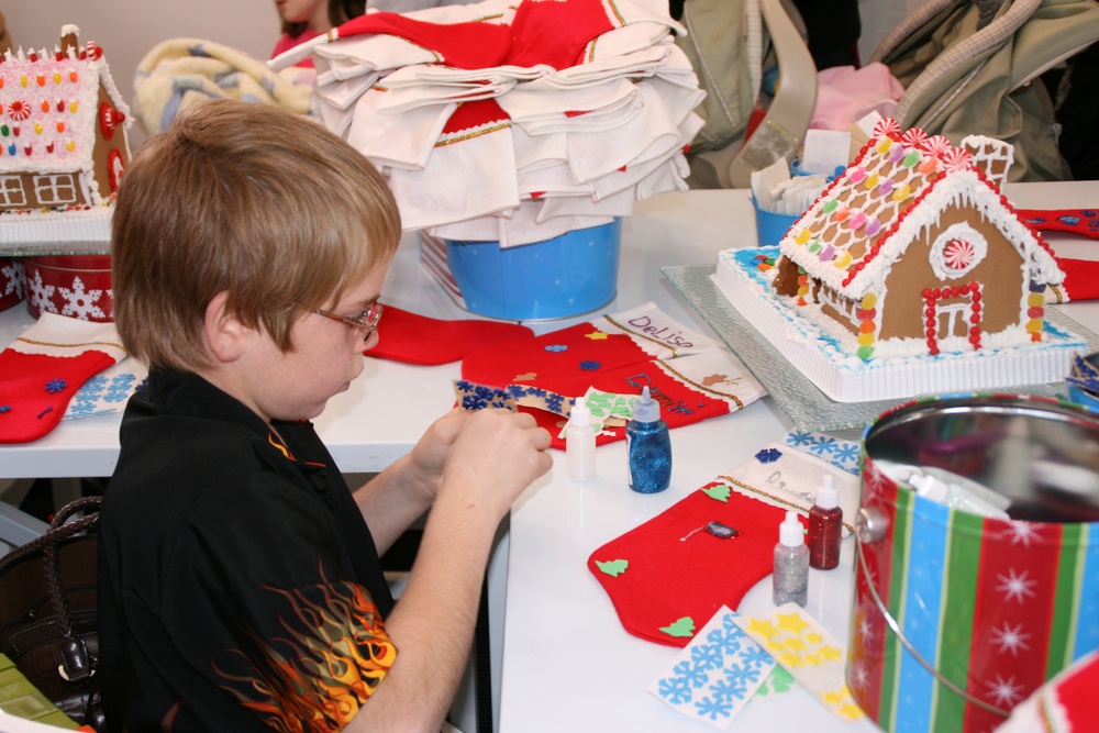 Young Boy Crafts Holiday Stocking at Operation Christmas Event