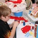 Young Boy Crafts Holiday Stocking at Operation Christmas Event