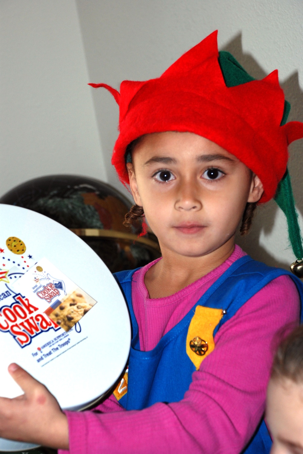 Young Girl Helps Pack Cookies for Marines in Barracks