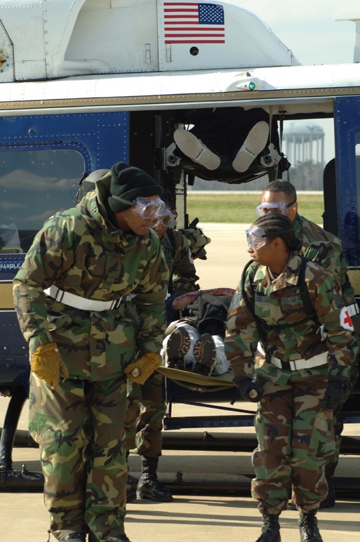 Medical Technicians Transport Patient from Helicopter During Exercise