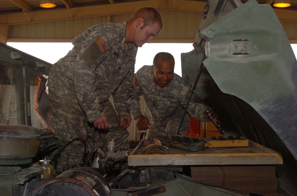 Soldiers Repair Humvee in Motor Pool