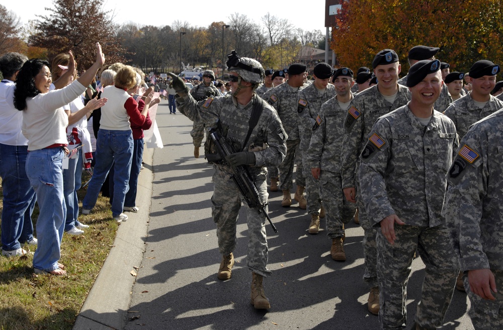 Joyful Homecoming: Woman Welcomes Soldier at 101st Airborne Division Parade