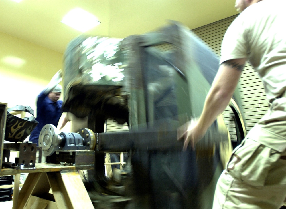 Welders Conduct Roll Test on Humvee Egress Trainer in Iraq