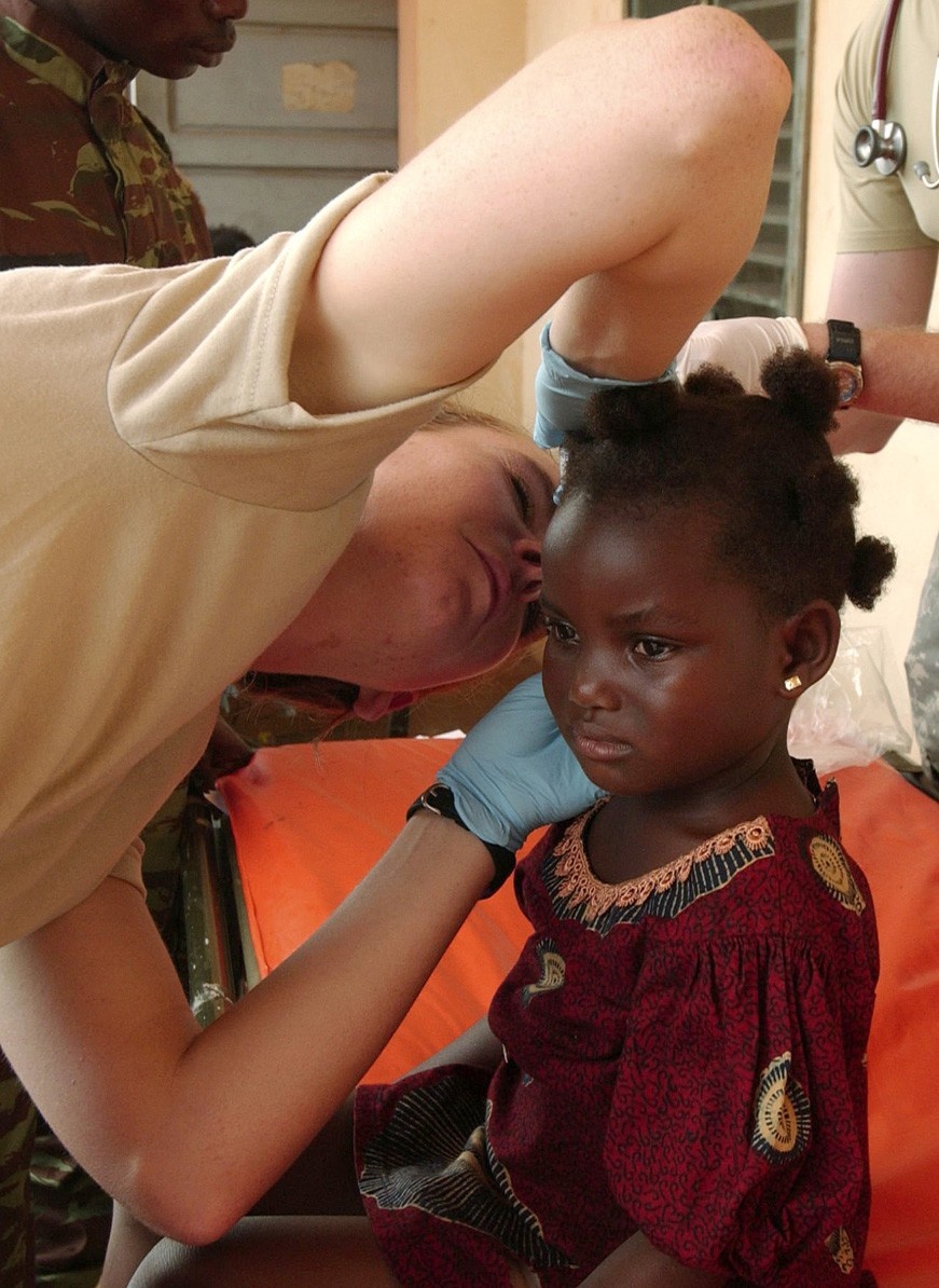U.S. Army Officer Provides Medical Care to Beninese Girl in Africa