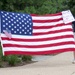 Bryson Family Honors 9/11 Cyclists with Flag and Sign