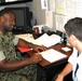 Marine Recruiter Reviews Contract with Prospective Recruit