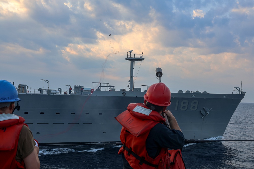 GM3 Daniel Kininmonth uses an M-14 rifle to send a phone and distance line to the USNS Joshua Humphreys (T-AO 188)