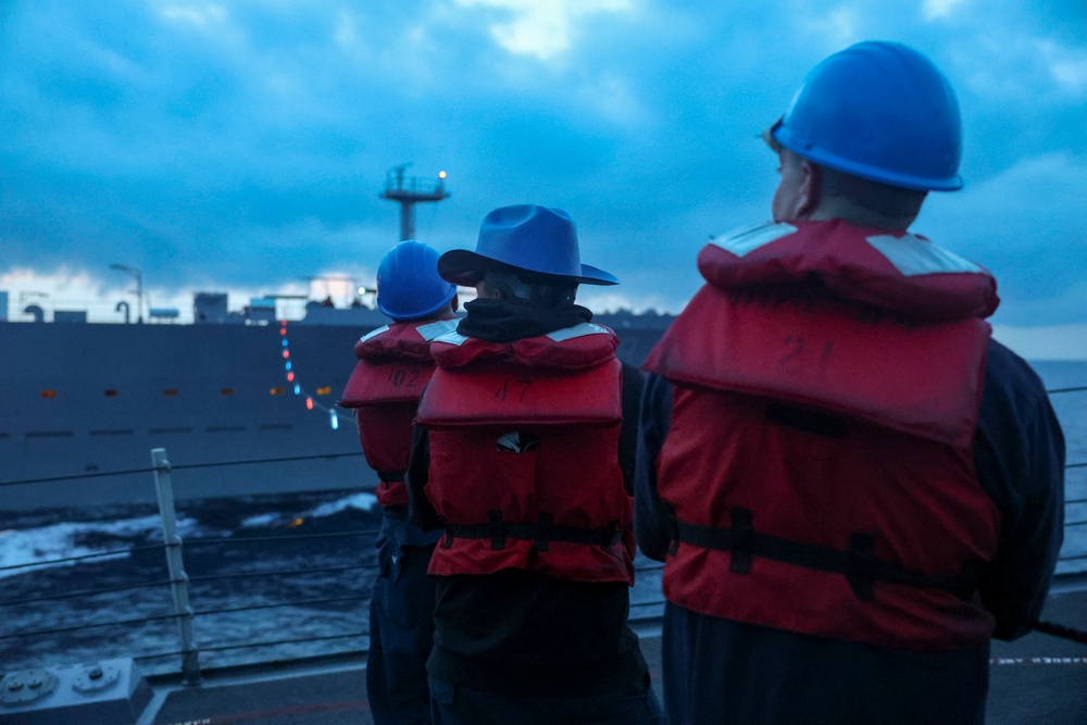U.S. Navy Sailors maintain the required tension on the phone and distance line during a COMPTUEX replenishment-at-sea