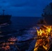 U.S. Navy Sailors conduct a night time replenishment-at-sea during COMPTUEX
