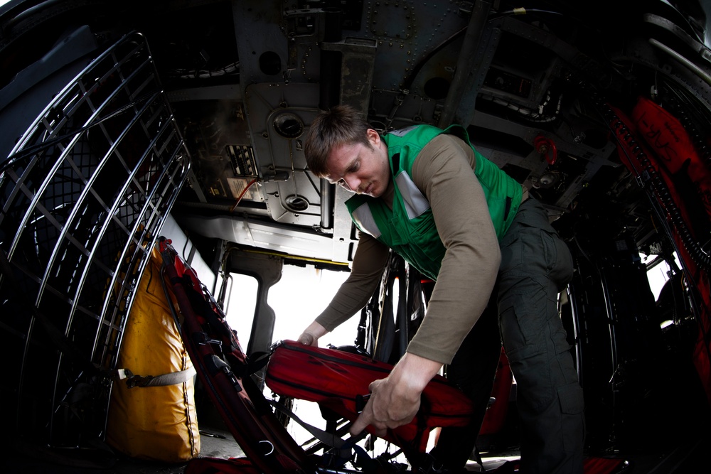 Naval Aircrewman Checks Survival Gear in an MH-60S Sea Hawk