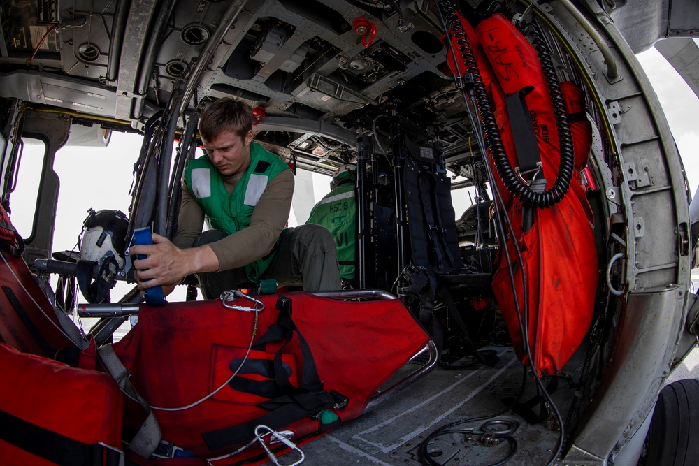 Naval Aircrewman Checks Survival Gear in an MH-60S Sea Hawk
