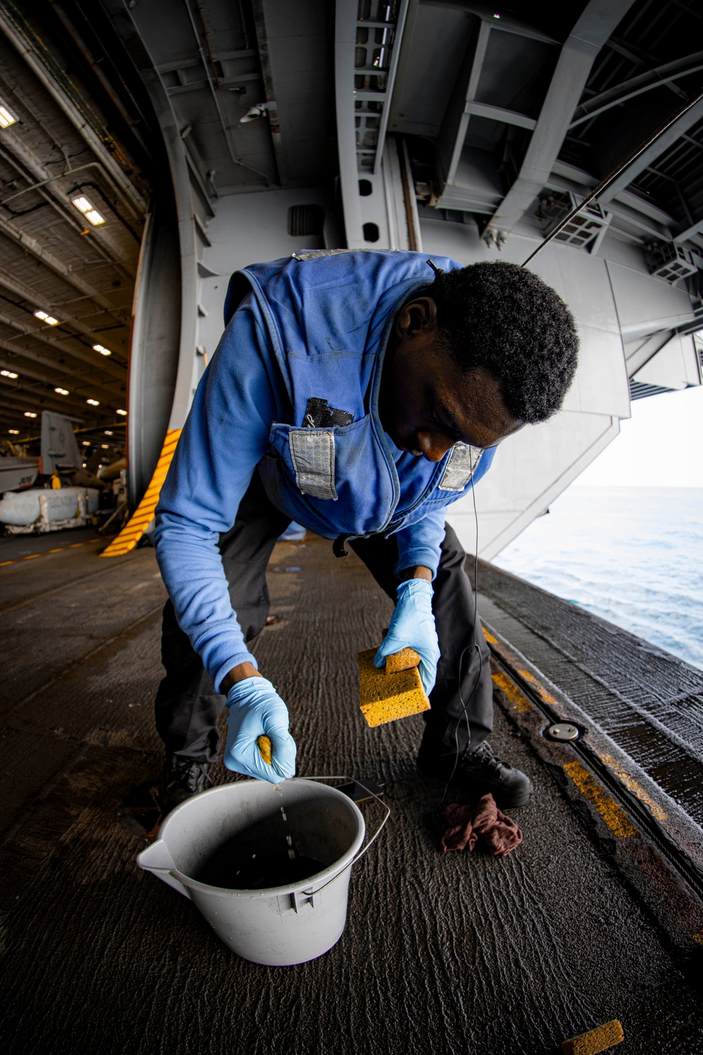 USS Gerald R. Ford (CVN 78) Air Department Sailor Conducts Non-Skid Maintenance