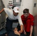 Sailors aboard the USS John Finn conduct a medical training team drill in the Philippine Sea