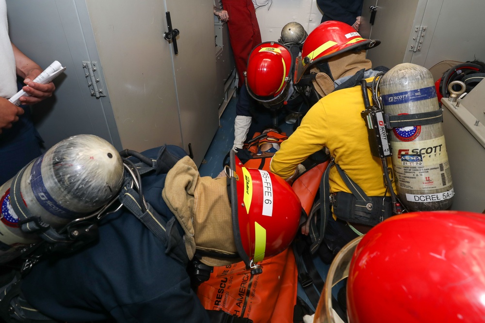 Sailors aboard the USS John Finn conduct a medical training team drill in the Philippine Sea