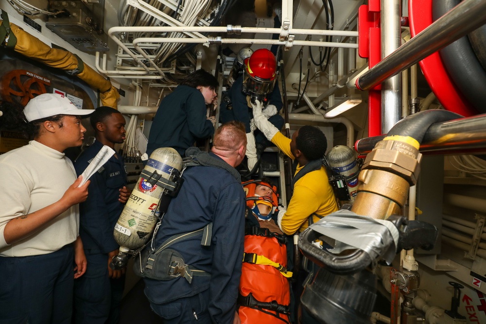 Sailors aboard the USS John Finn conduct a medical training team drill in the Philippine Sea