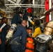 Sailors aboard the USS John Finn conduct a medical training team drill in the Philippine Sea