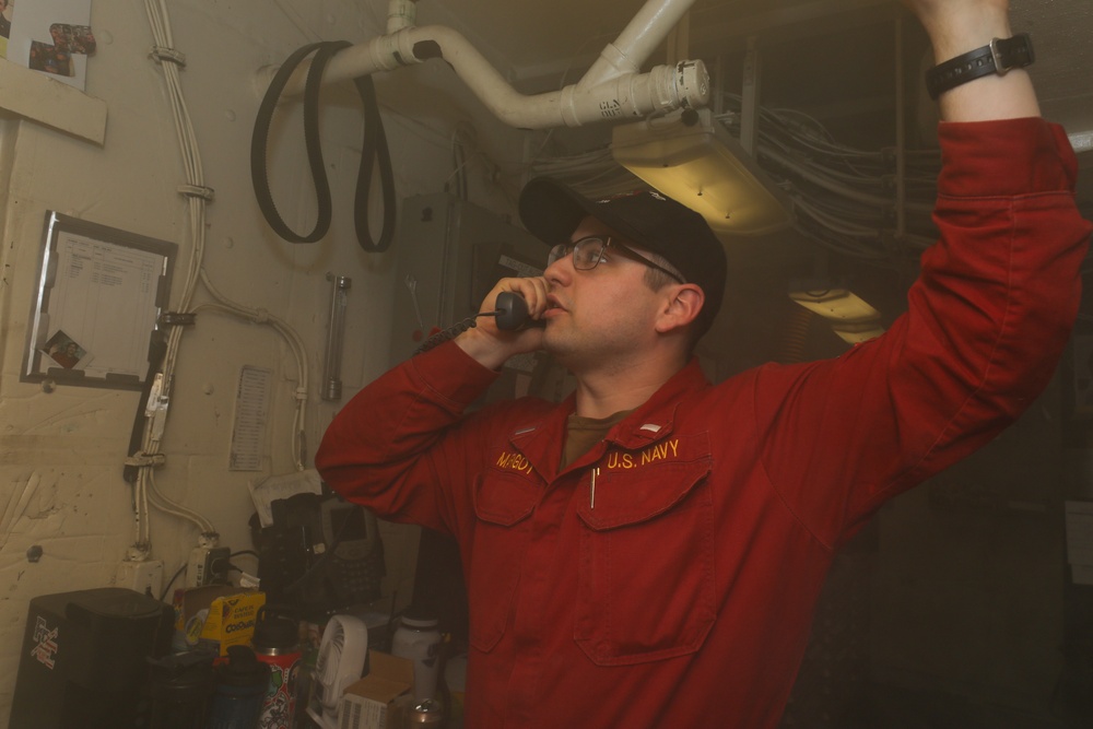 Sailors aboard the USS John Finn conduct a medical training team drill in the Philippine Sea