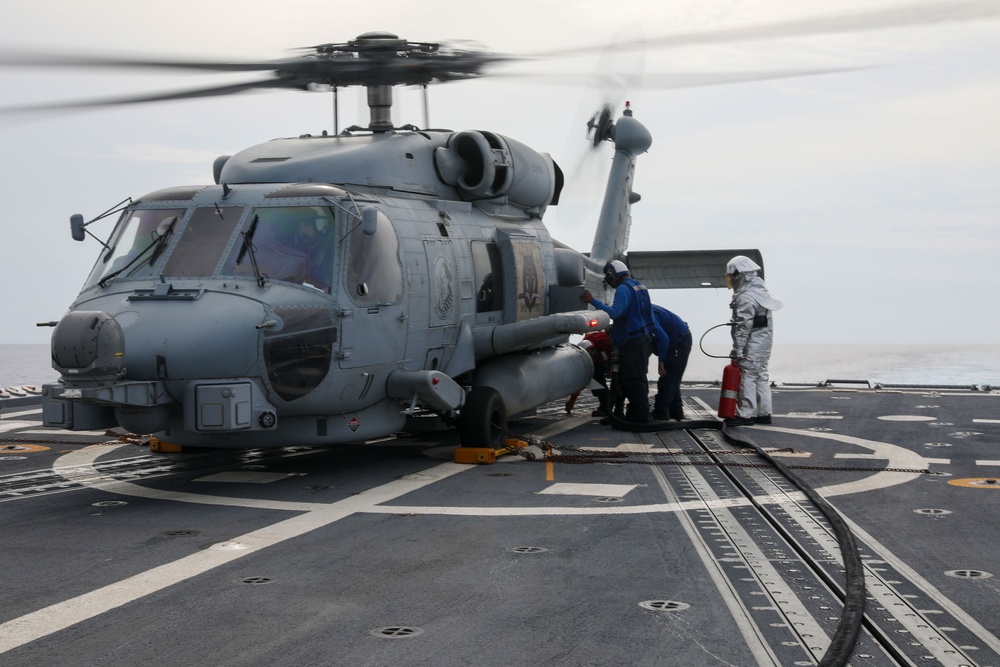 Sailors aboard the USS John Finn conduct flight quarters in the Philippine Sea