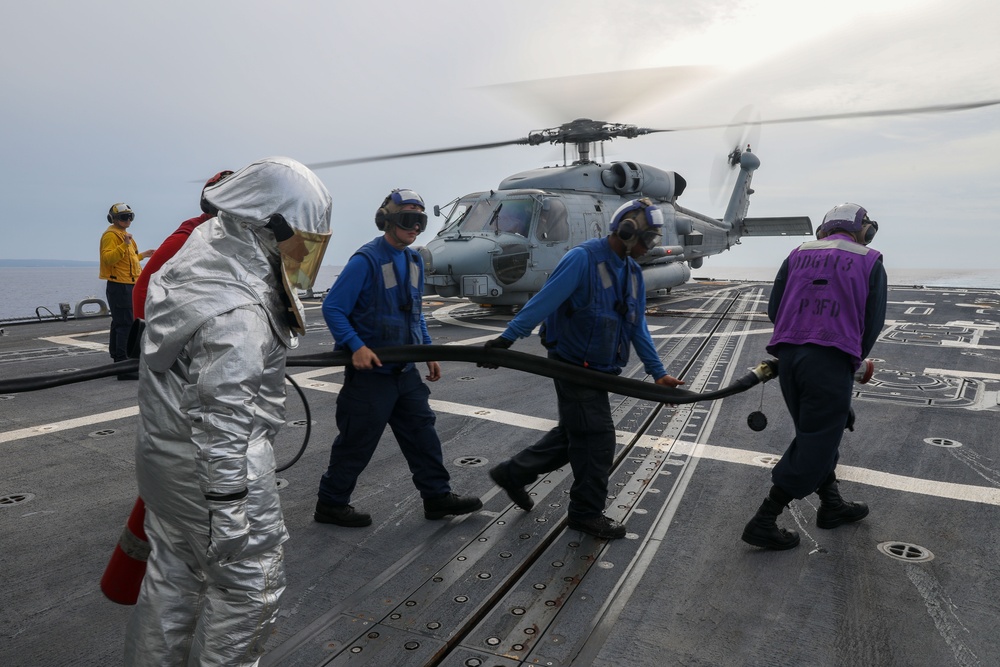 Sailors aboard the USS John Finn conduct flight quarters in the Philippine Sea