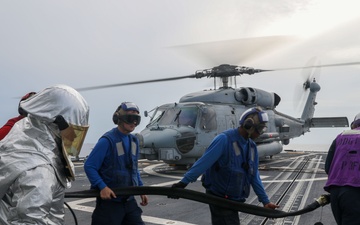 Sailors aboard the USS John Finn conduct flight quarters in the Philippine Sea