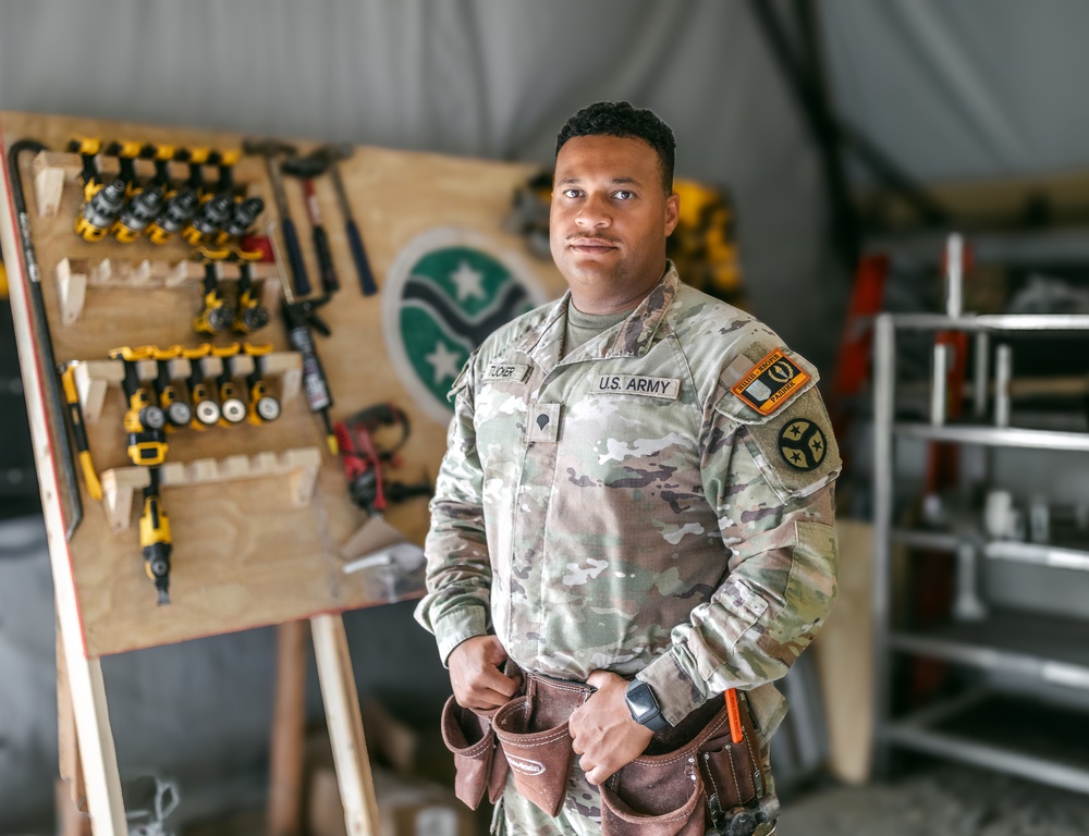 Spc. Tucker Builds Weapons Rack in Support of JMTG-U