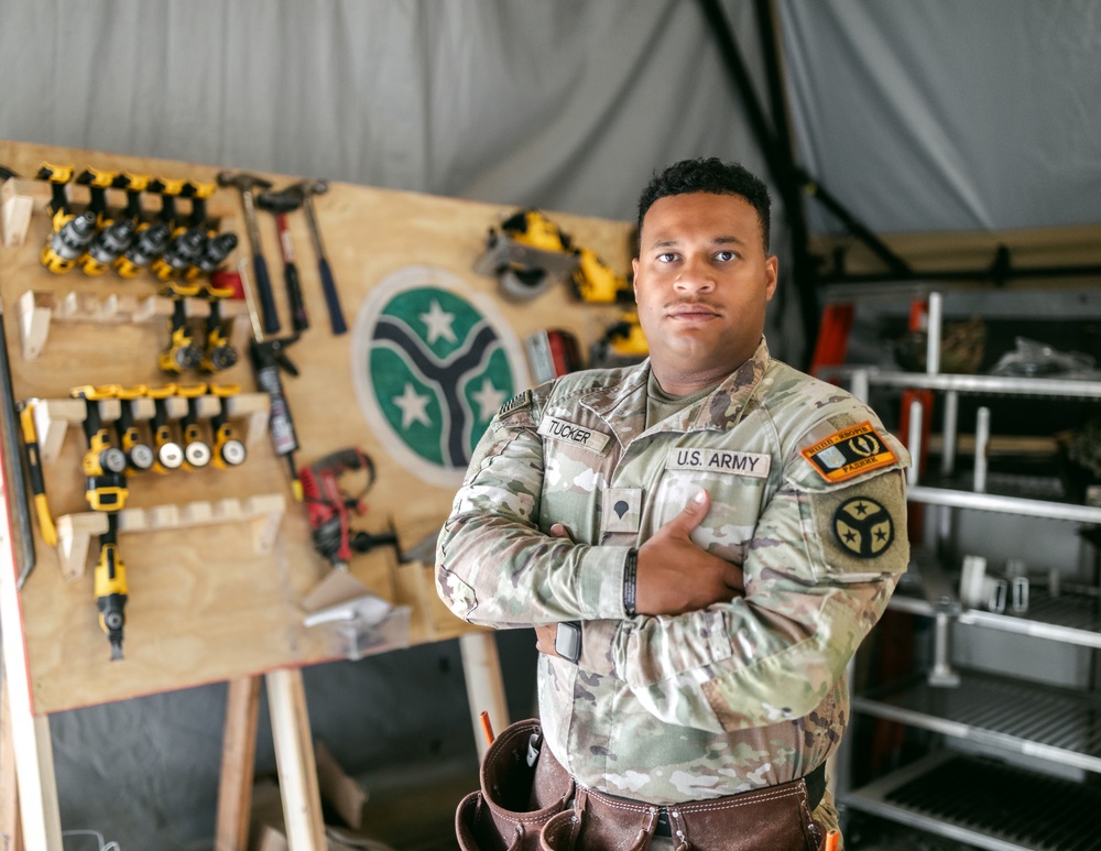 Spc. Tucker Builds Weapons Rack in Support of JMTG-U