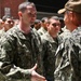 Navy Father hands son Navy ball cap following completion of Battle Stations.