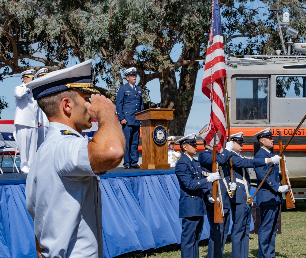 U.S. Coast Guardsman salutes colors during Southwest District Change of Command ceremony