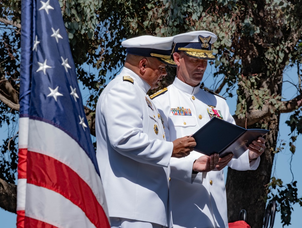 U.S. Coast Guard Admiral receives award during Change of Command ceremony