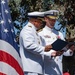 U.S. Coast Guard Admiral receives award during Change of Command ceremony