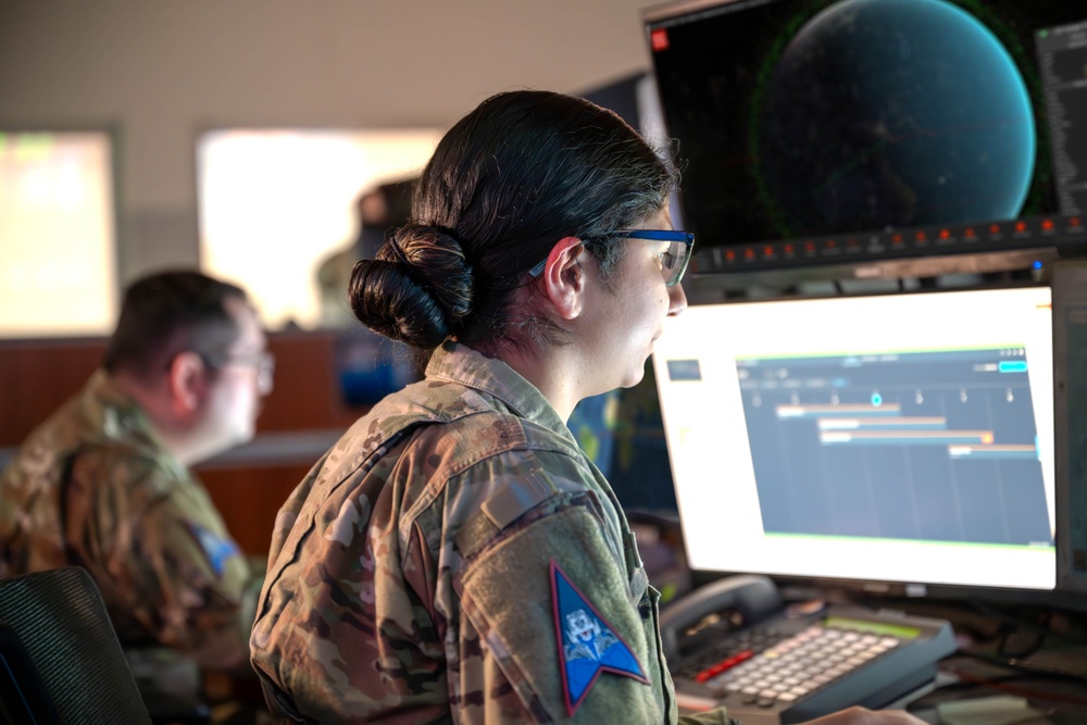 Combined Space Operations Center (CSpOC) staff monitors workstations.  (Screen images have been altered for operational security). Combined Space Operations Center (CSpOC) staff monitors workstations.  (Screen images have been altered for operational security).