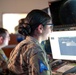 Combined Space Operations Center (CSpOC) staff monitors workstations.  (Screen images have been altered for operational security).