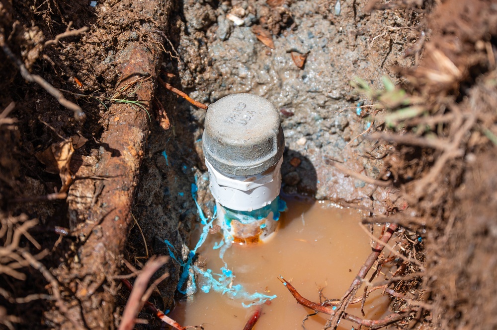 Members of the 647th Civil Engineer Squadron repair a water pipe on JBPHH