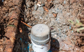 Members of the 647th Civil Engineer Squadron repair a water pipe on JBPHH
