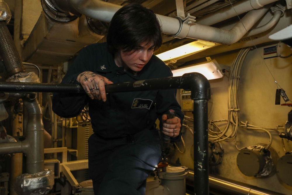Sailors aboard the USS John Finn conduct an engineering training team drill in the South China Sea